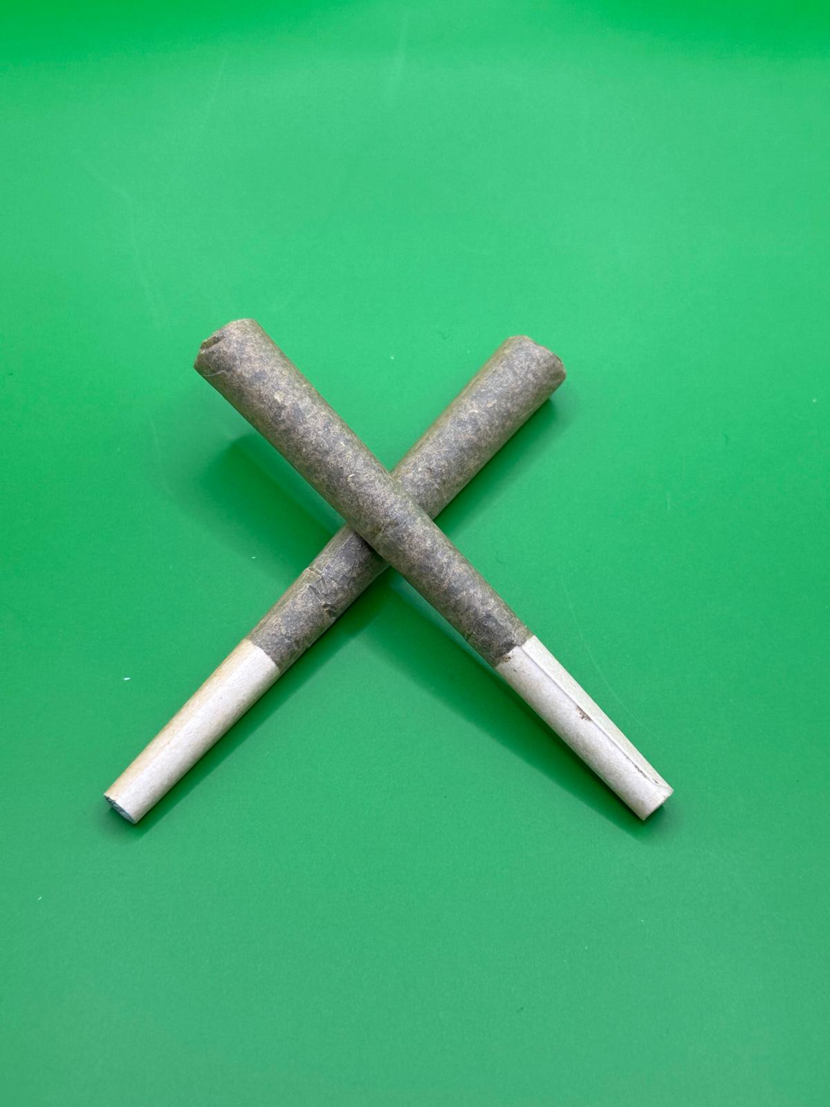 Incredible Hulk Thca Pre-Rolls Two Thca Hemp Pre-Rolls Crossed In An X With White Filter Tips